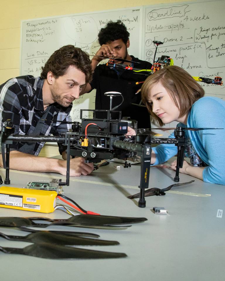 Engineering students working on drone