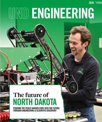 magazine cover shows a student working on a lunar robot