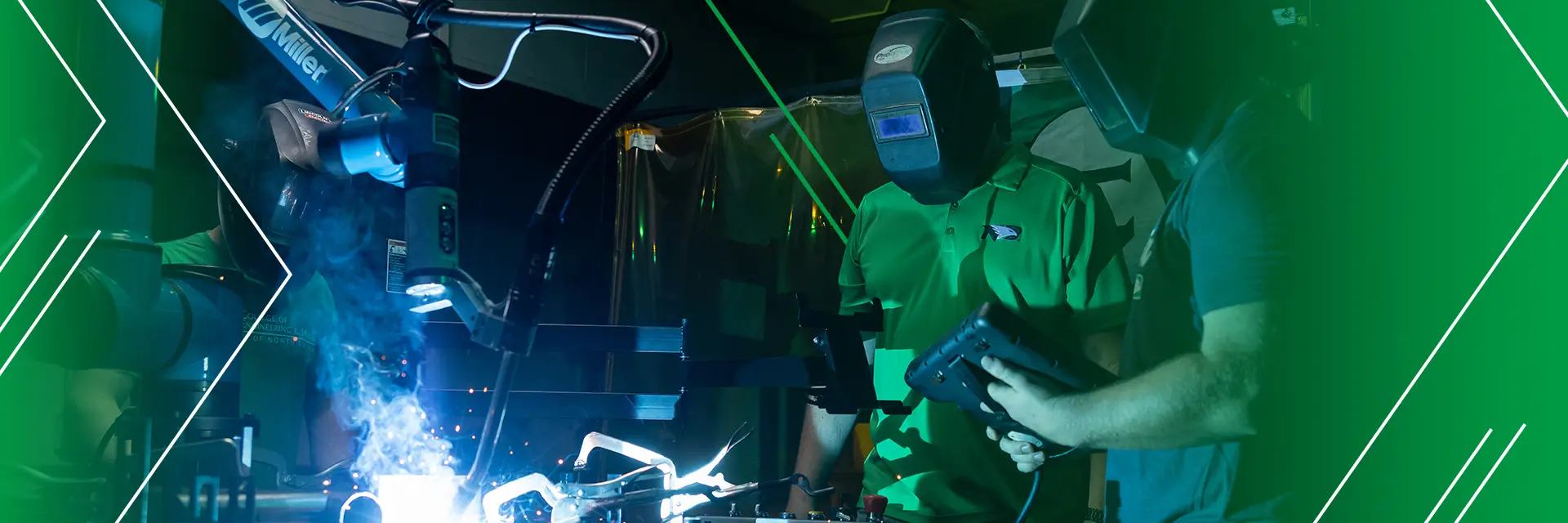 a faculty member and student engage in machine robot welding