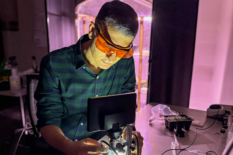 a man with safety goggles works on an experiement