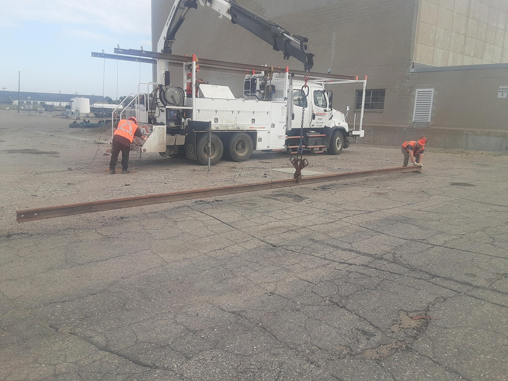 BNSF railway workers unloading the rail