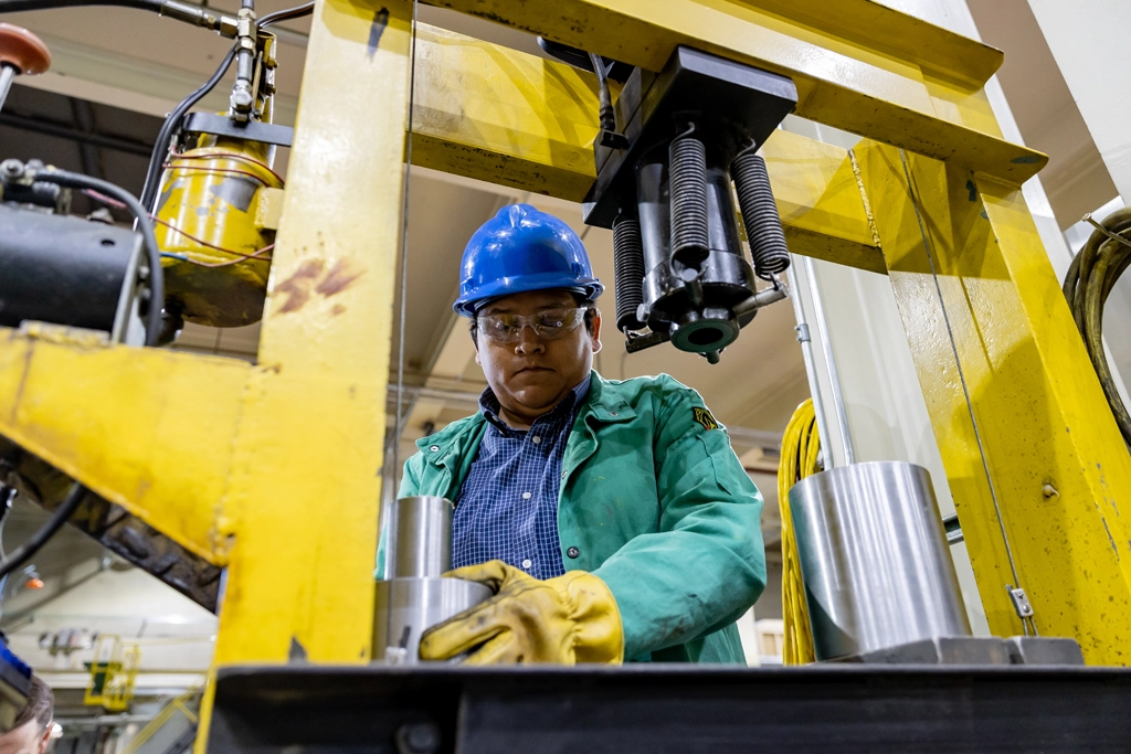 a man in safety gear works with equipment