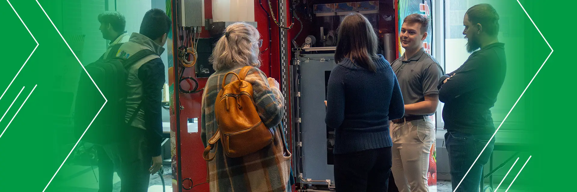 students demonstrate a slushy machine to attendees at the Senior Design Expo