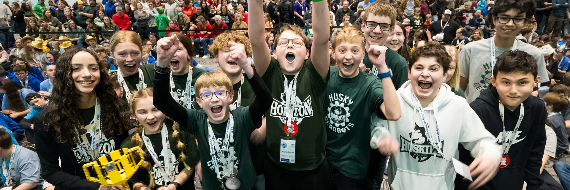 cheering students at LEGO robot event