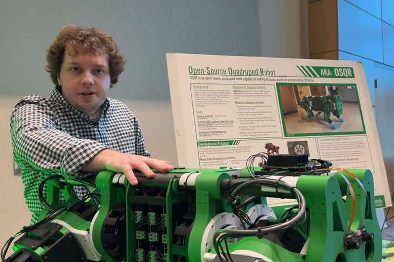 a student shows a quadruped robot