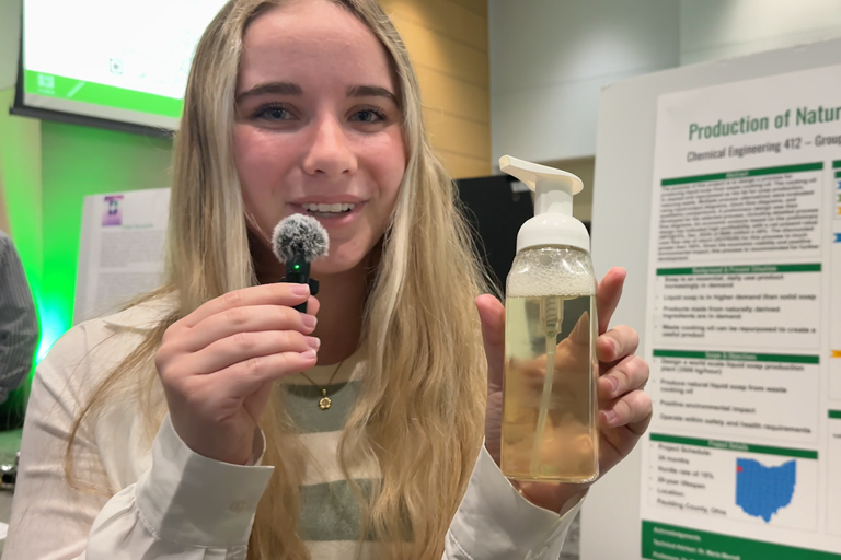 a girl with a microphone shows hand soap