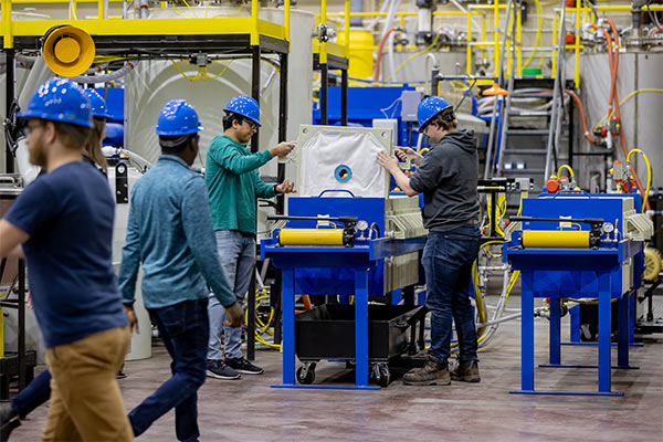 und engineering students working in plant