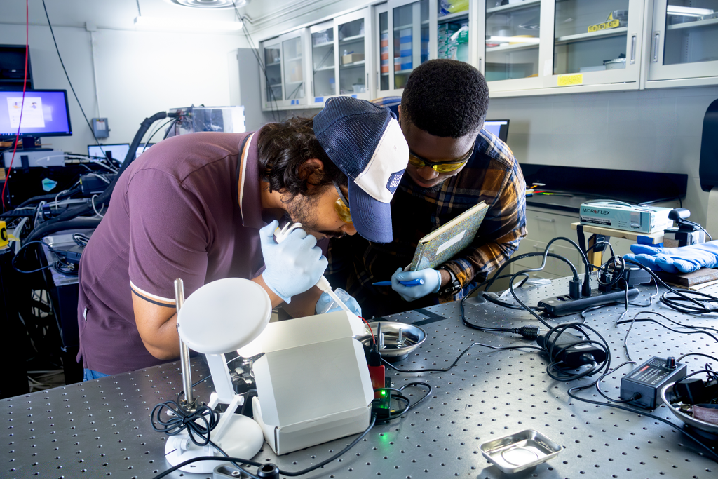 students work with an experiment in the hypersonics lab