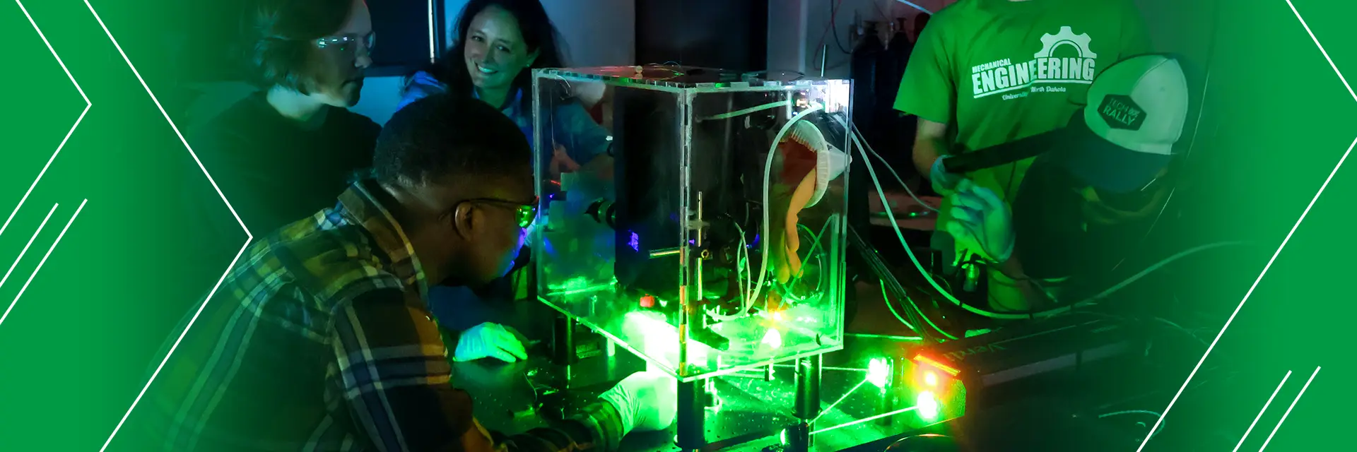 students in a hypersonics lab work with an enclosed plexiglas structure